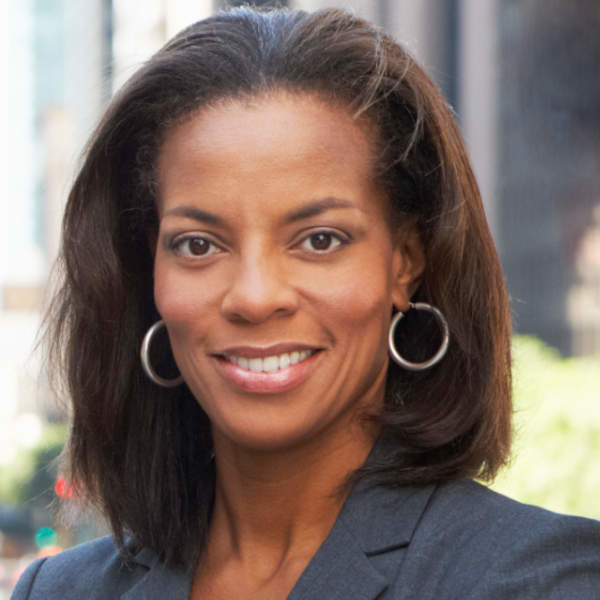 Professional woman smiling confidently outdoors.