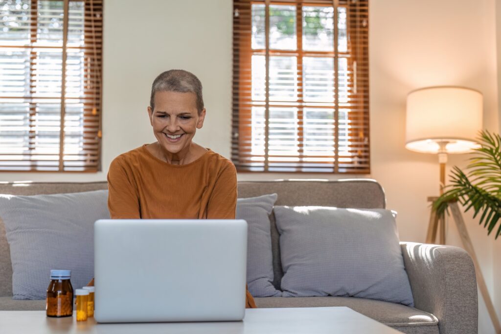 Senior woman checking remedy information on pharmacy website on laptop at home