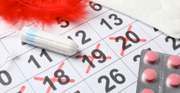 Menstruation period concept with calendar, close up